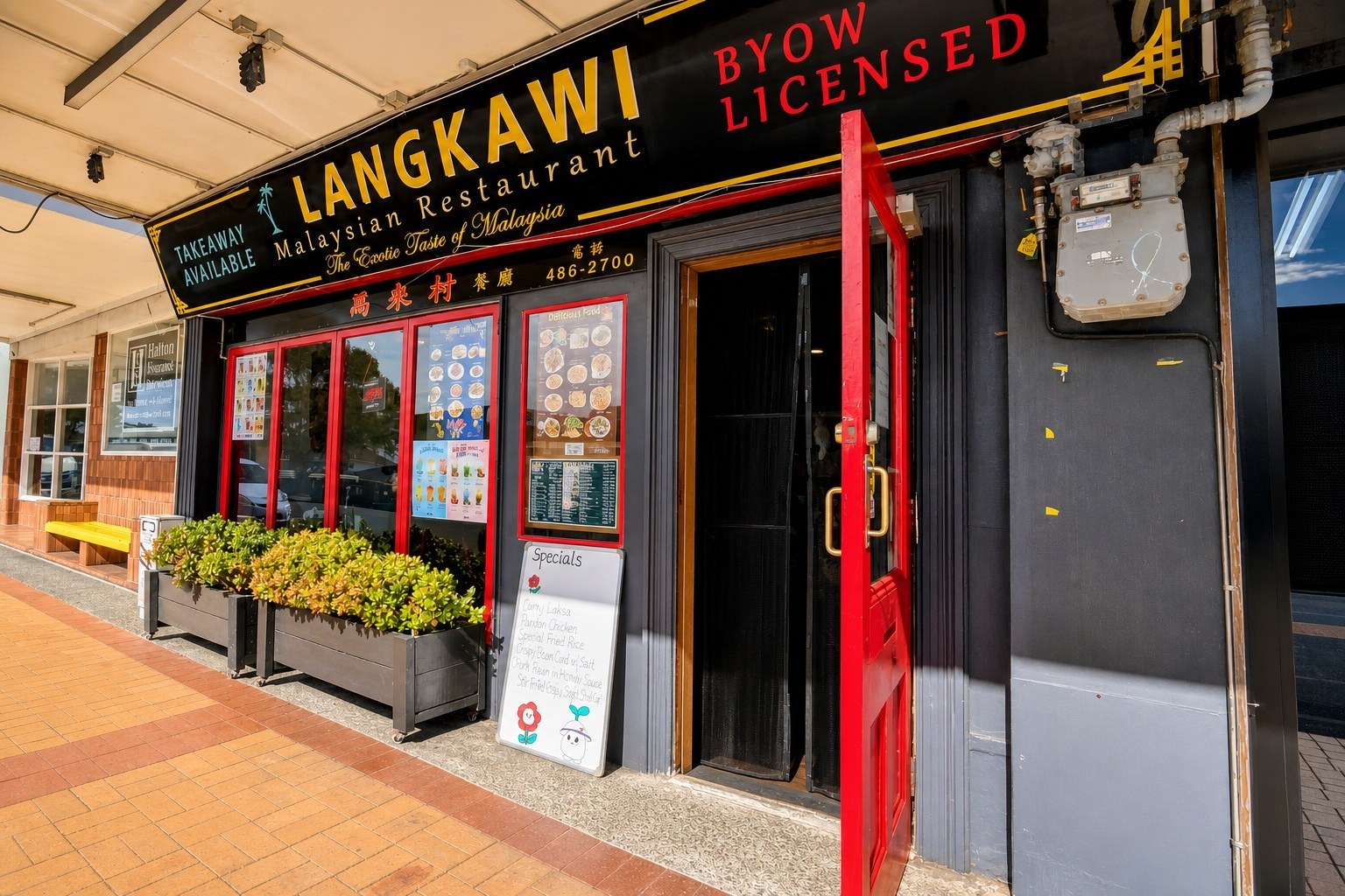 Langkawi Malaysian Restaurant sign and red entrance on Kitchener Road